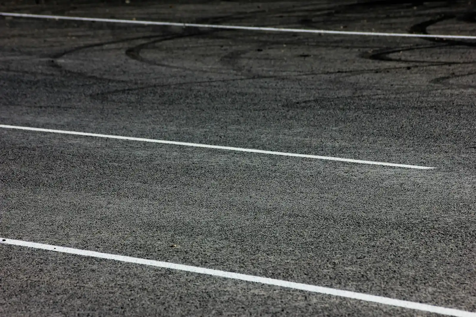 Asphalt parking lot with freshly painted white stall lines